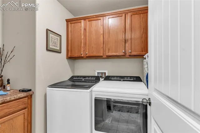 a view of washer and dryer with kitchen countertops