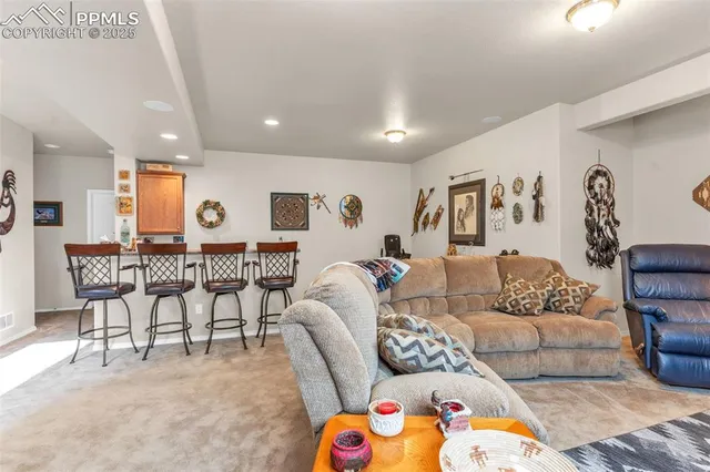 a living room with furniture and kitchen view