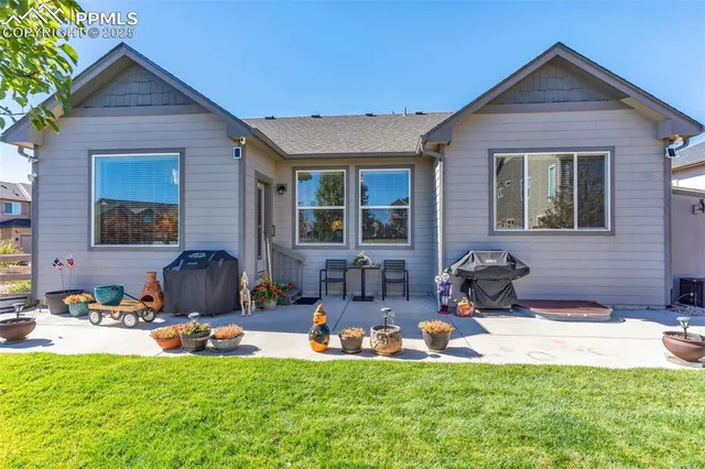 a view of a house with backyard sitting area and garden