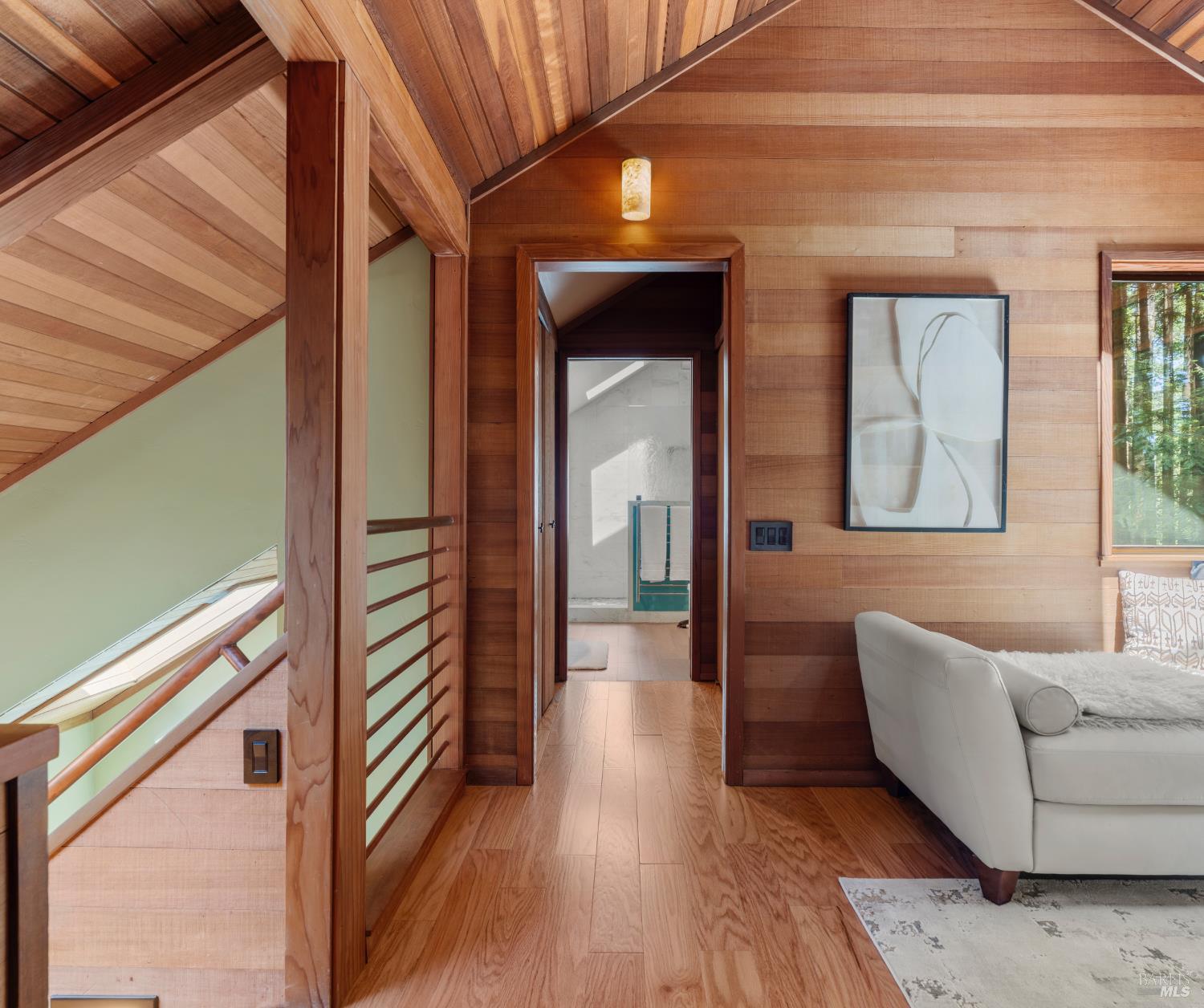 36419 East Ridge Road The Sea Ranch, CA 95497 - Photo 35 of 55 a hallway with couches wooden floor and a large window with wooden floor