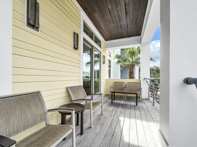 a view of a patio with a table and chairs and wooden floor