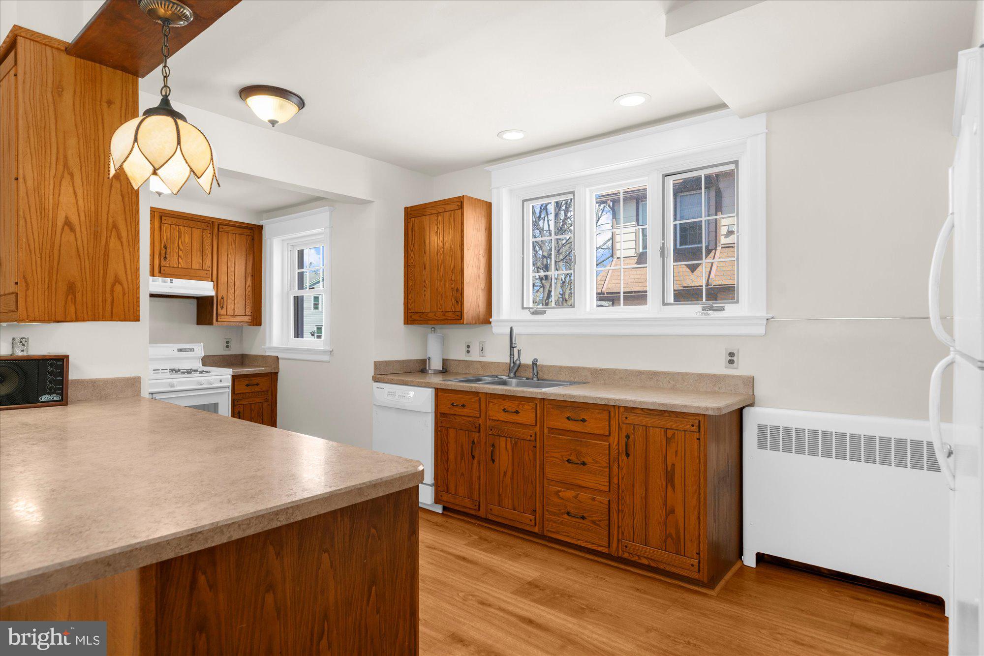 206 North Manoa Road Havertown, PA 19083 - Photo 11 of 50 a large kitchen with stainless steel appliances granite countertop a sink and wooden floors