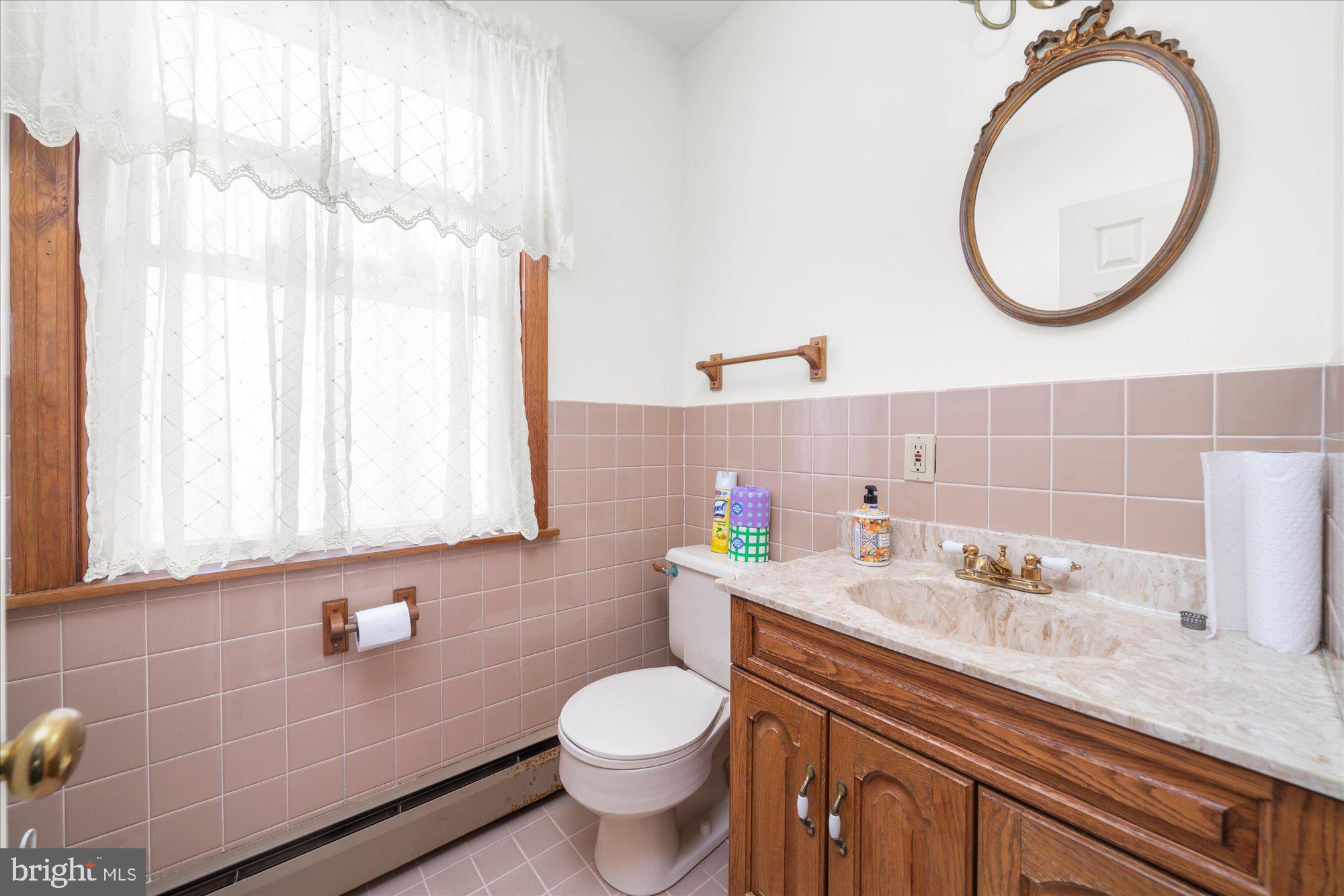 206 North Manoa Road Havertown, PA 19083 - Photo 18 of 50 a bathroom with a granite countertop toilet sink and mirror