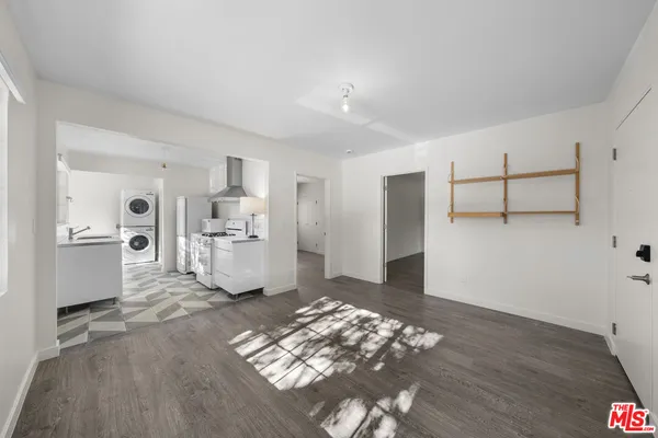 a living room with furniture and white walls