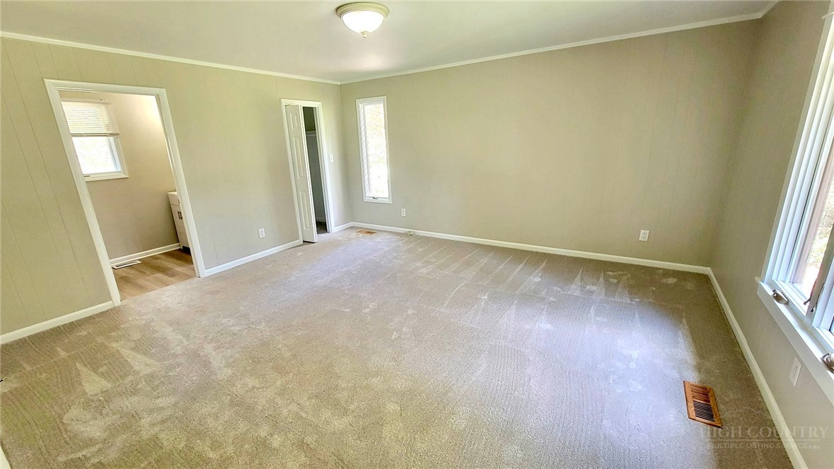 172 Yarrow Lane Boone, NC 28607 - Photo 14 of 30 an empty room with wooden floor and windows
