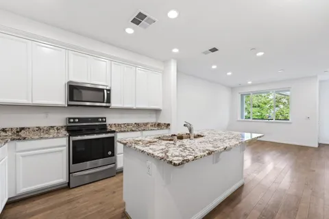 a kitchen with a stove a sink and a microwave