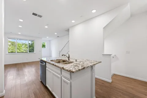 a kitchen with a sink stove and refrigerator