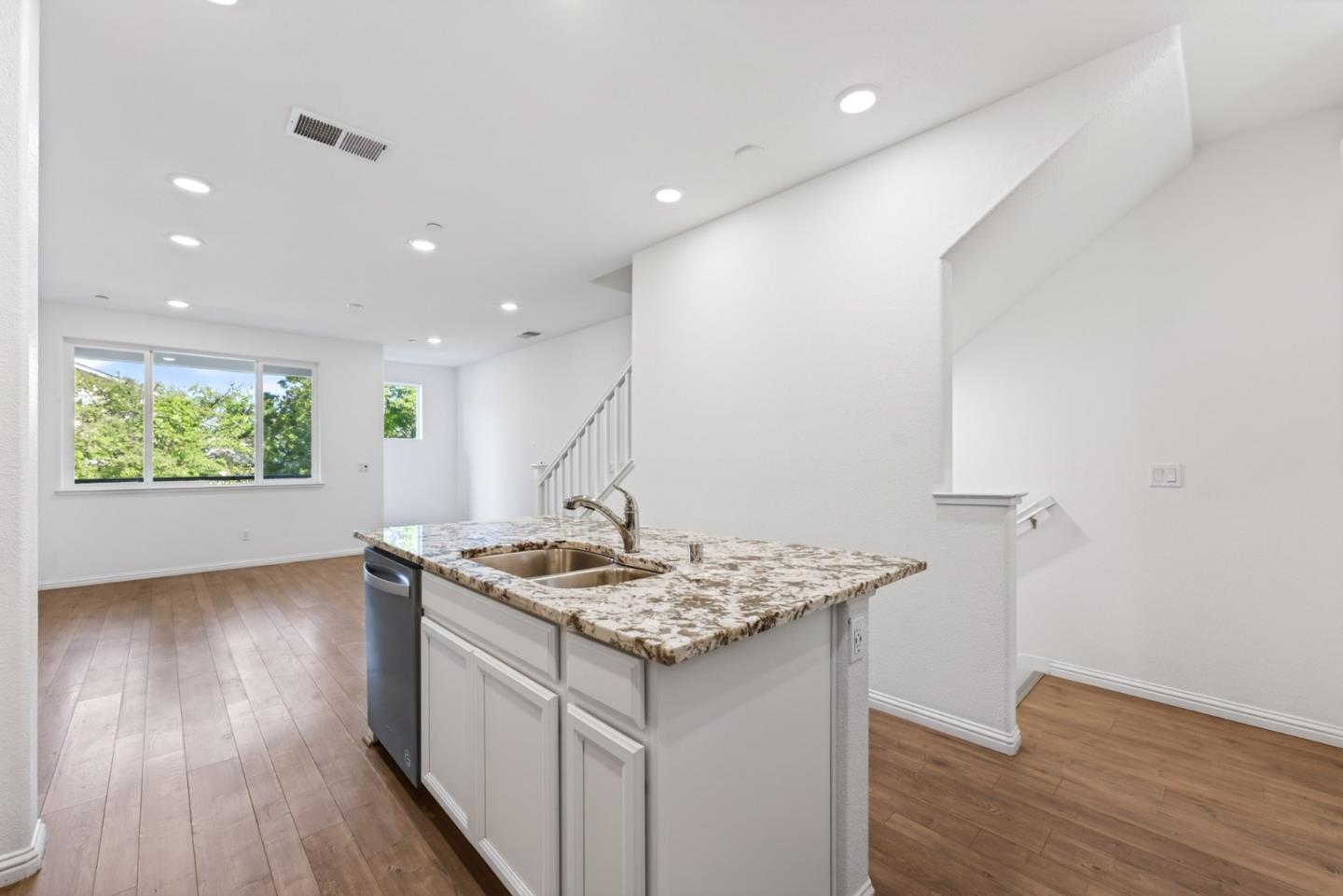 2580 Gimelli Way San Jose, CA 95133 - Photo 16 of 50 a kitchen with stainless steel appliances granite countertop a sink a stove and a wooden floors