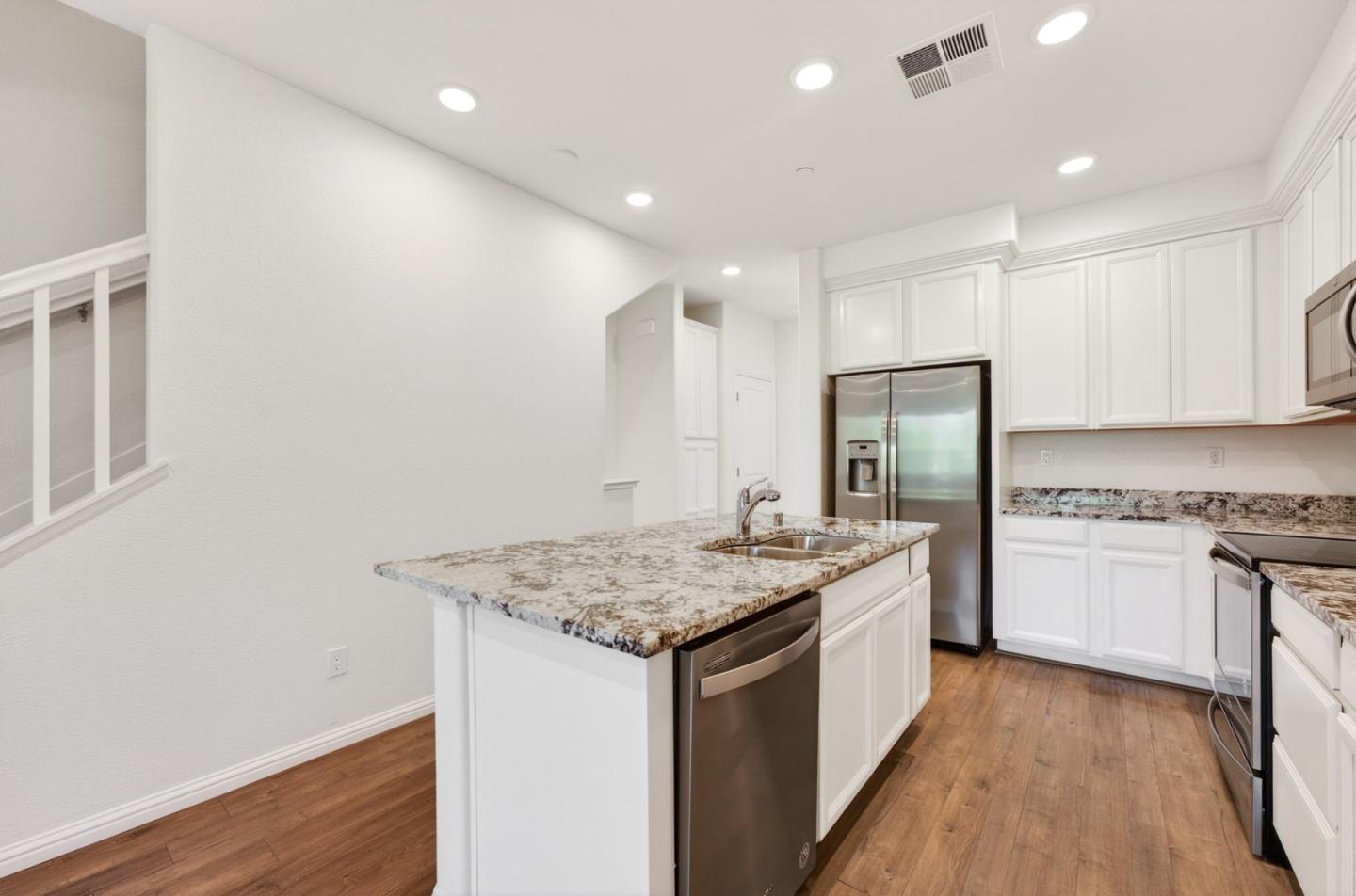 2580 Gimelli Way San Jose, CA 95133 - Photo 17 of 50 a kitchen with a sink stove and refrigerator