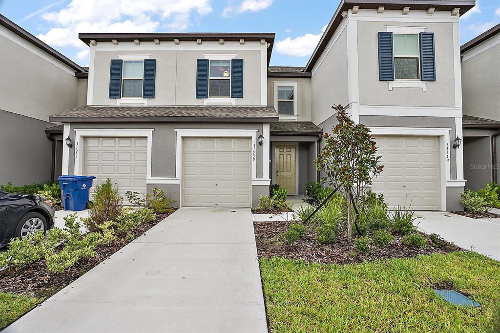 31539 Blue Passing Loop Wesley Chapel, FL 33545 - Photo 1 of 1 a front view of a house with garden