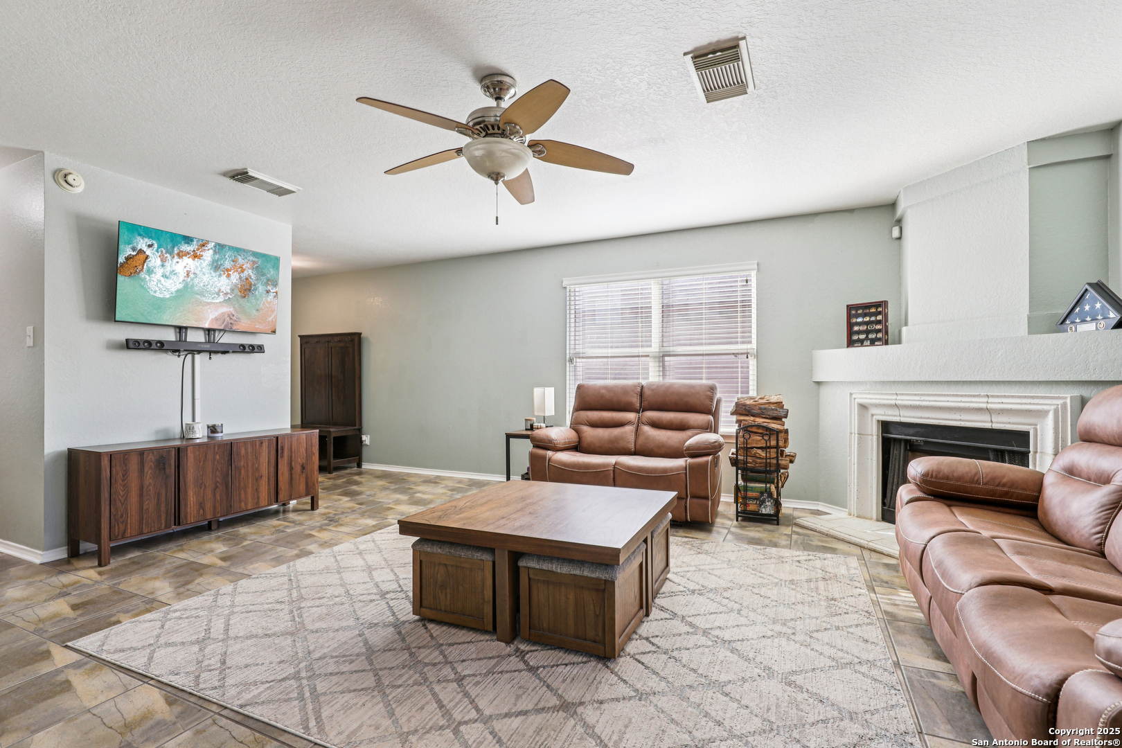 8915 Gathering Pass Converse, TX 78109 - Photo 11 of 37 a living room with furniture and a flat screen tv