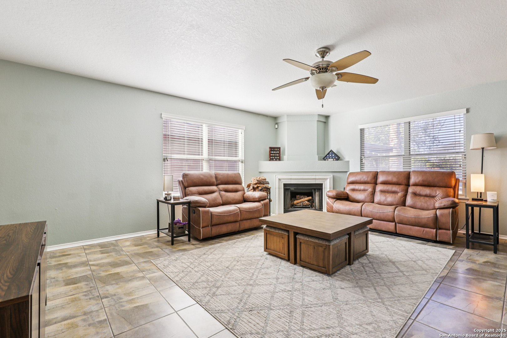 8915 Gathering Pass Converse, TX 78109 - Photo 13 of 37 a living room with furniture and a fireplace