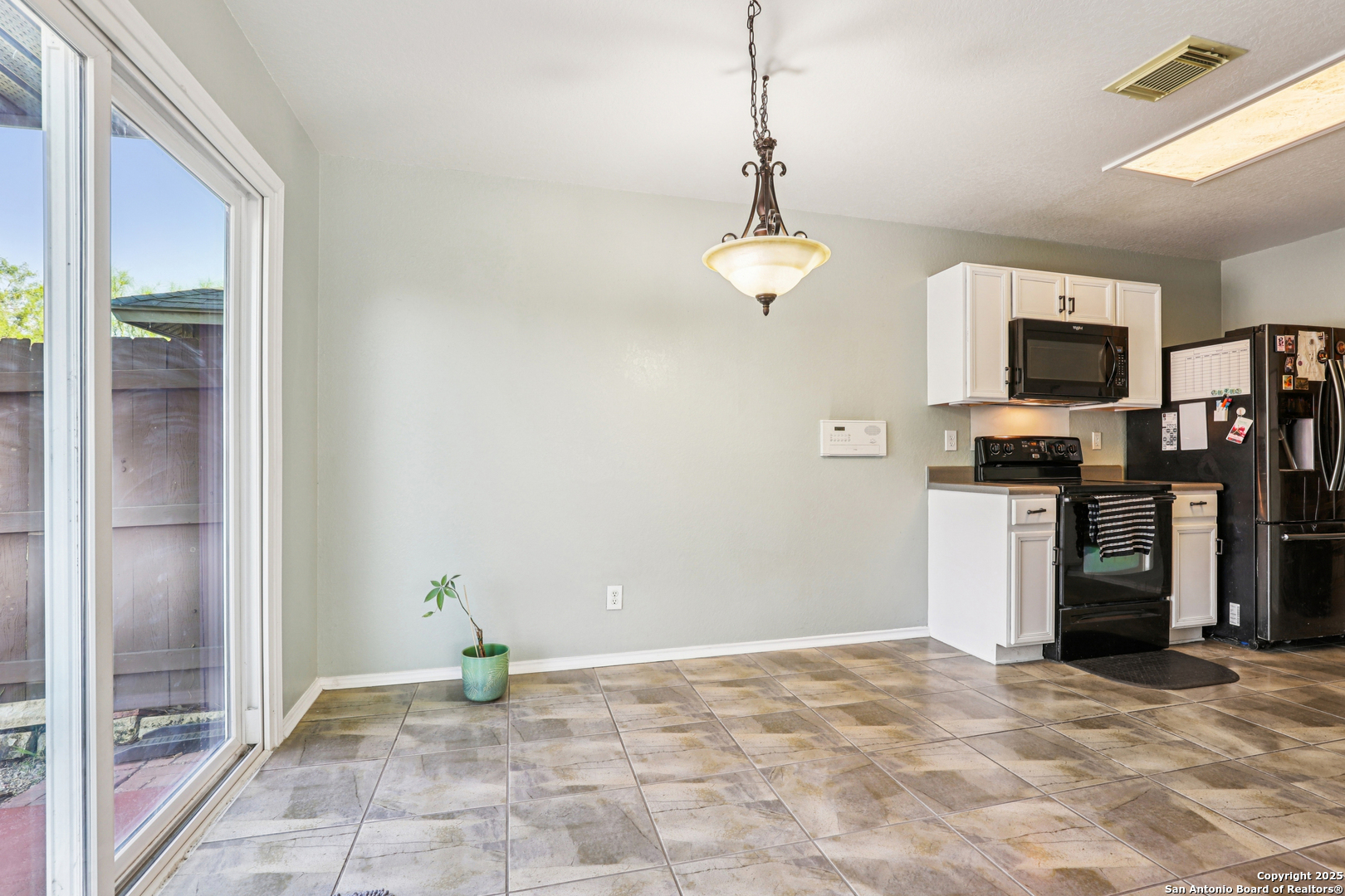 8915 Gathering Pass Converse, TX 78109 - Photo 14 of 37 a view of a kitchen with a sink and microwave