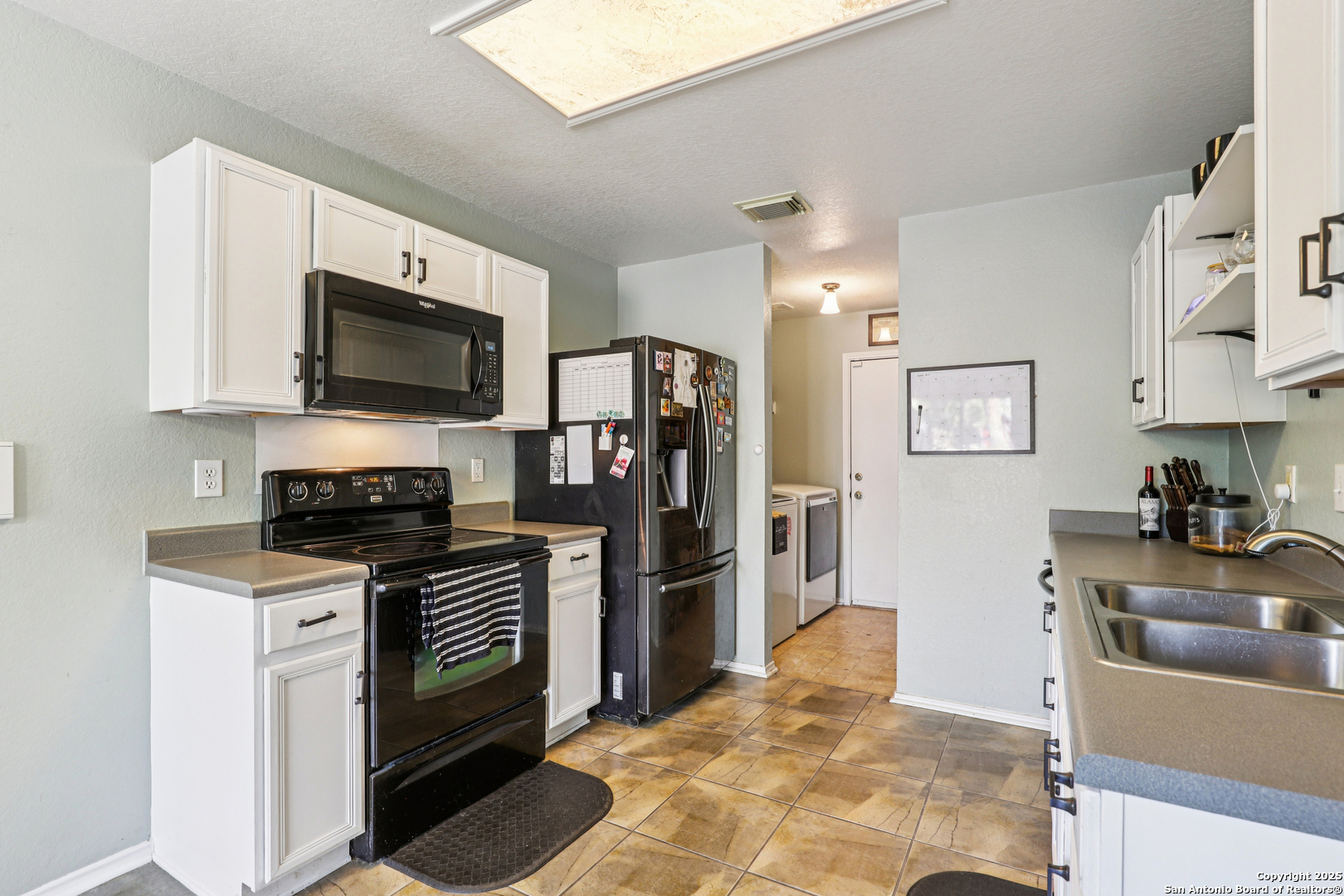 8915 Gathering Pass Converse, TX 78109 - Photo 16 of 37 a kitchen with stainless steel appliances granite countertop a refrigerator stove and sink