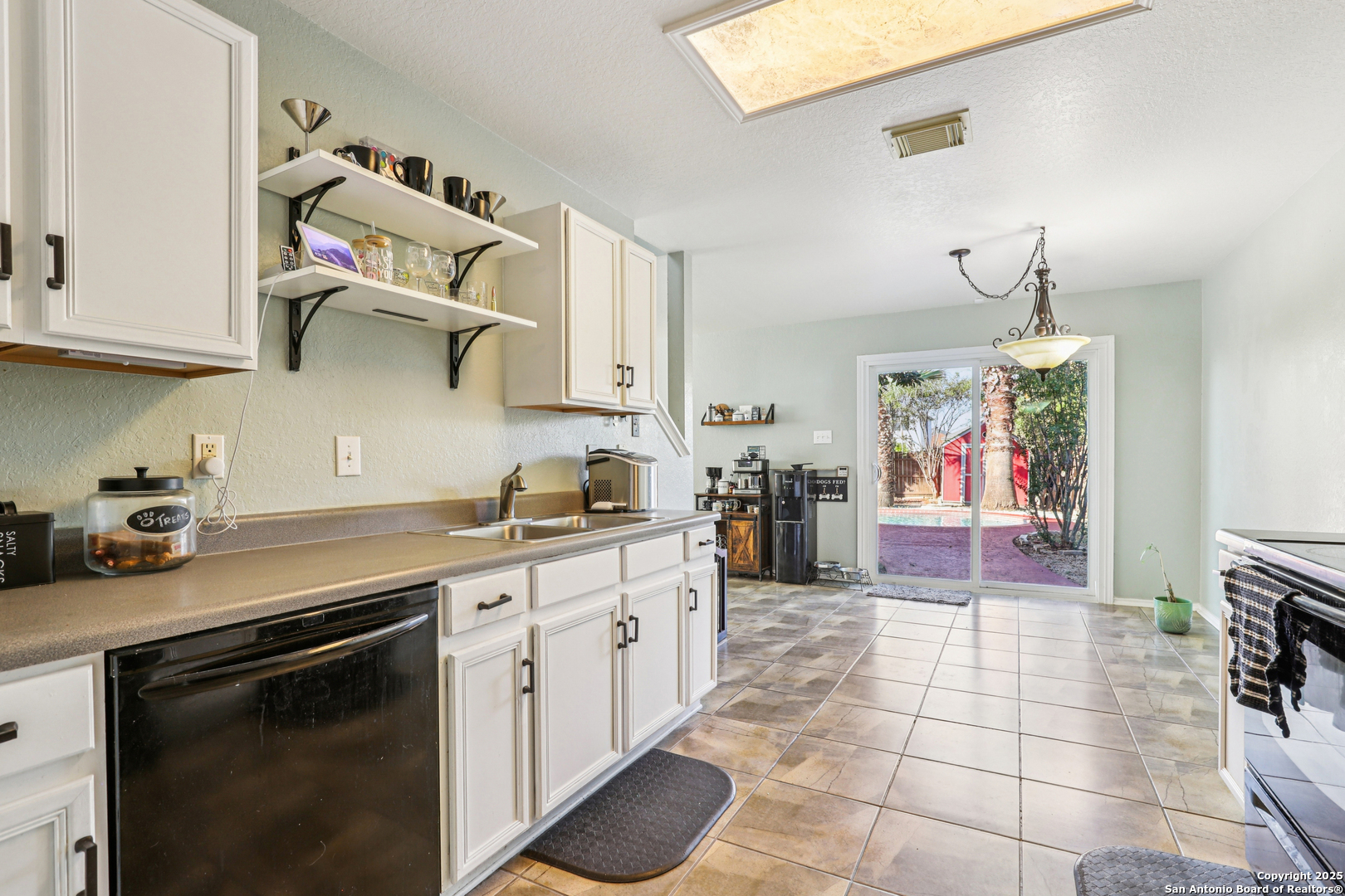 8915 Gathering Pass Converse, TX 78109 - Photo 17 of 37 a kitchen with a sink cabinets and appliances