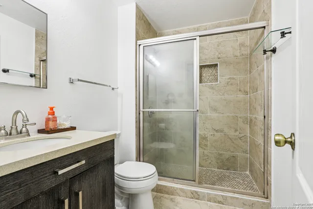 a view of a livingroom with a ceiling fan and window