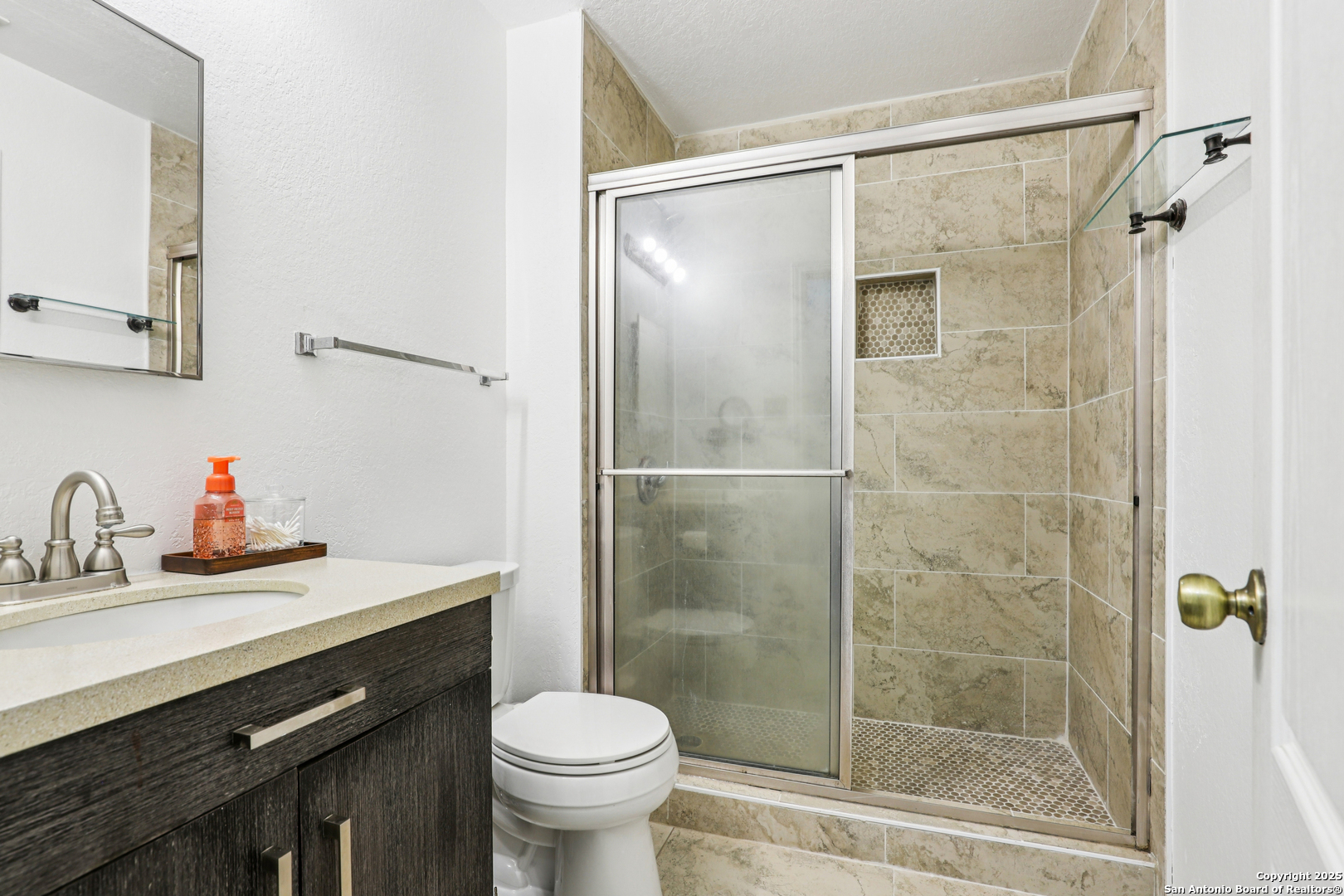 8915 Gathering Pass Converse, TX 78109 - Photo 18 of 37 a bathroom with a sink and a mirror