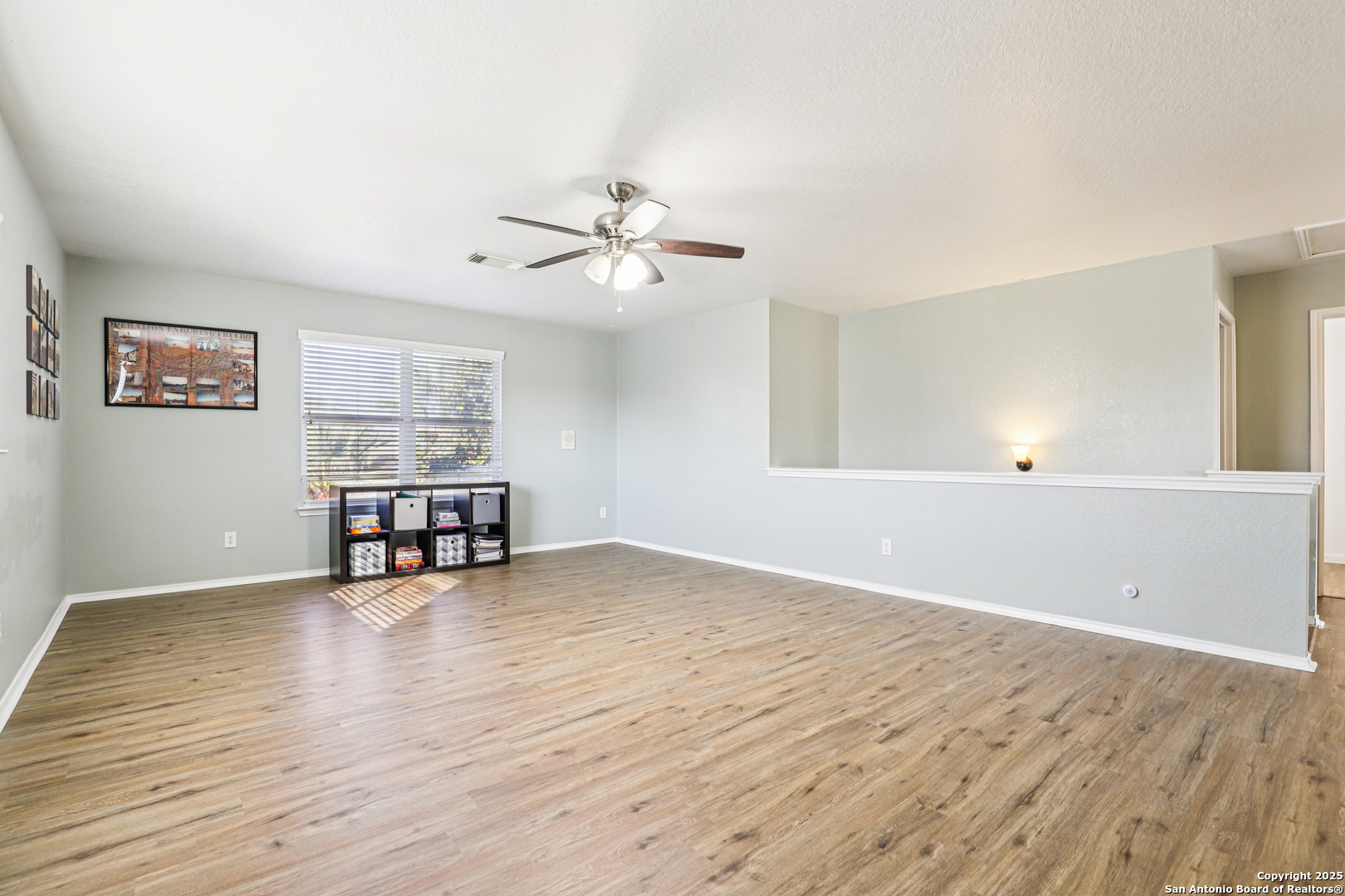 8915 Gathering Pass Converse, TX 78109 - Photo 19 of 37 a view of a room with wooden floor and ceiling fan
