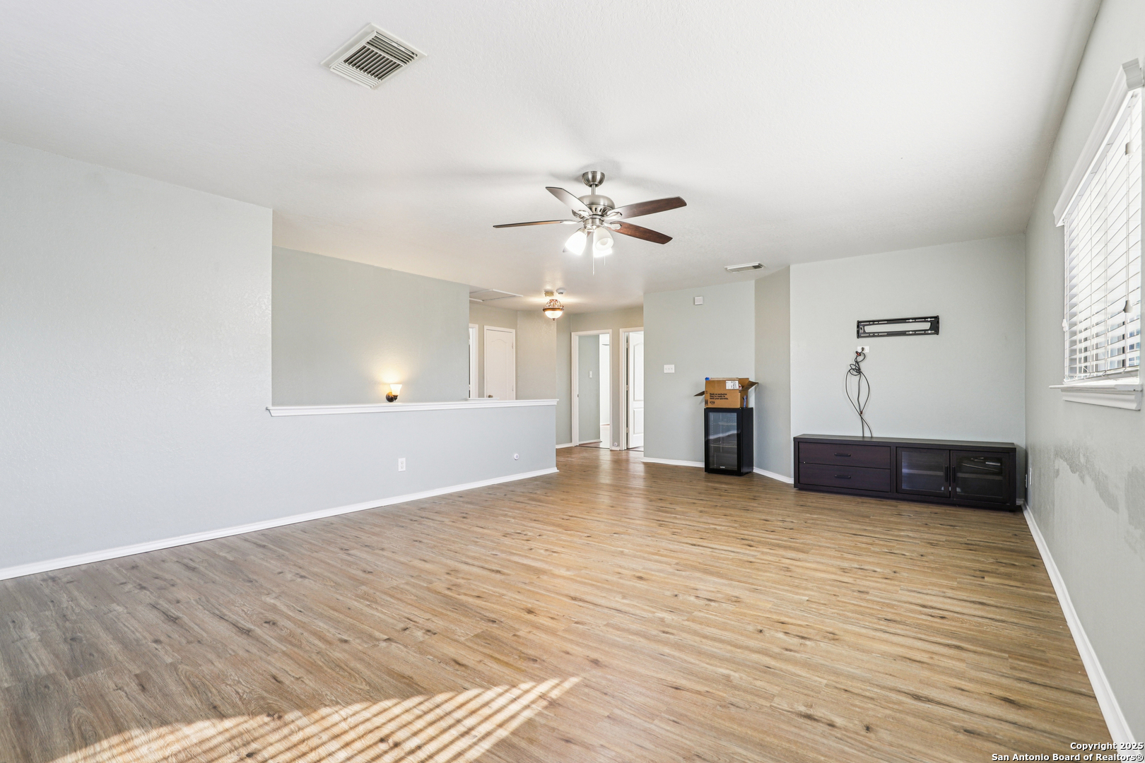 8915 Gathering Pass Converse, TX 78109 - Photo 20 of 37 a view of a livingroom with a ceiling fan and window