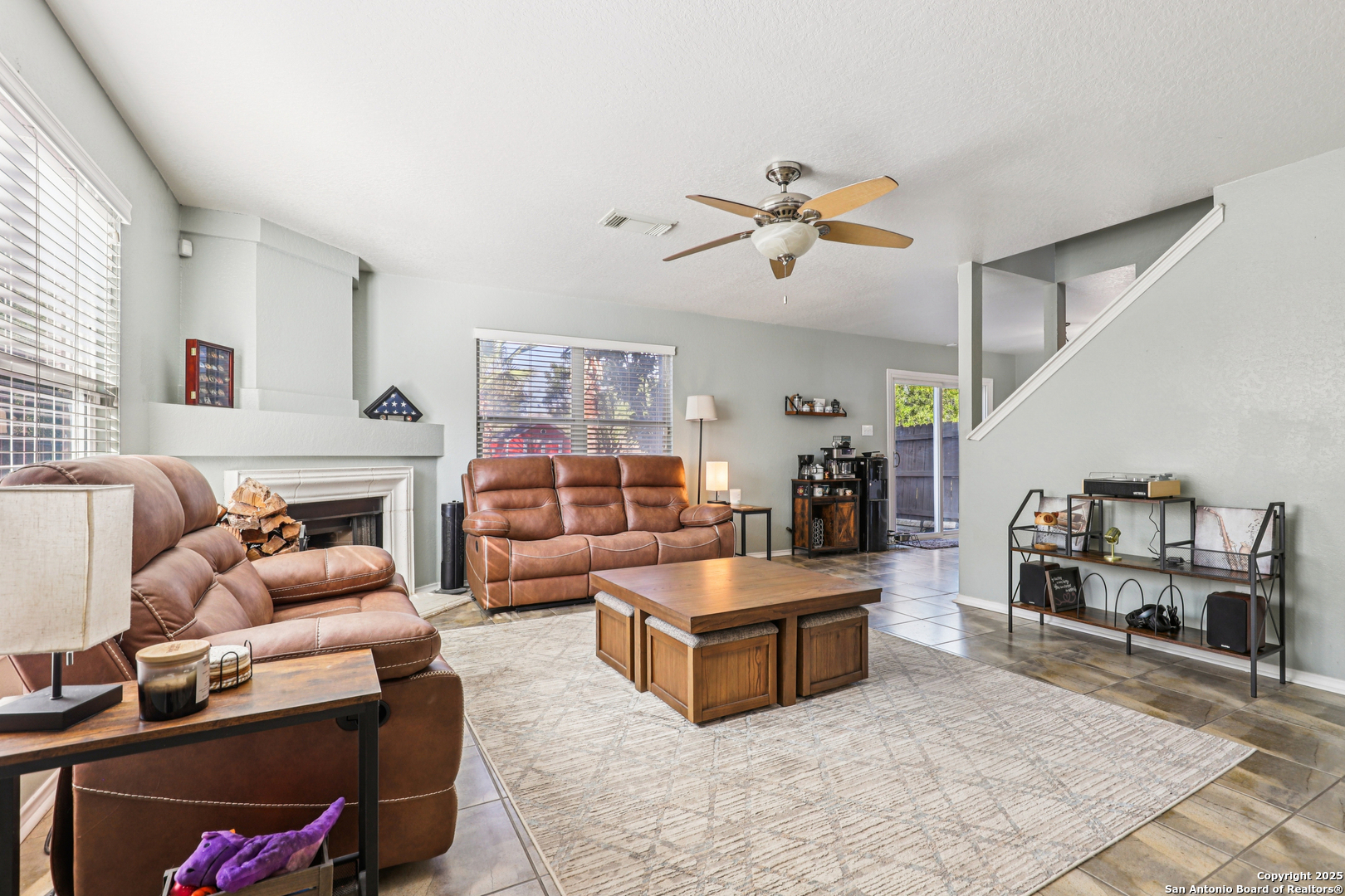 8915 Gathering Pass Converse, TX 78109 - Photo 2 of 37 a living room with fireplace furniture and a wooden floor