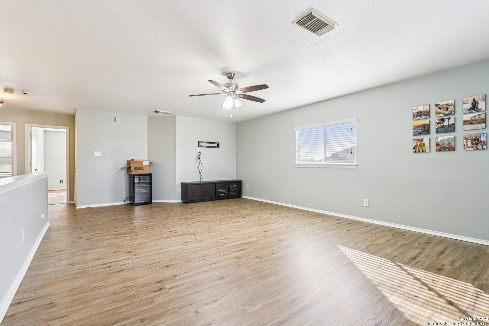 8915 Gathering Pass Converse, TX 78109 - Photo 21 of 37 a view of an empty room with window and a ceiling fan