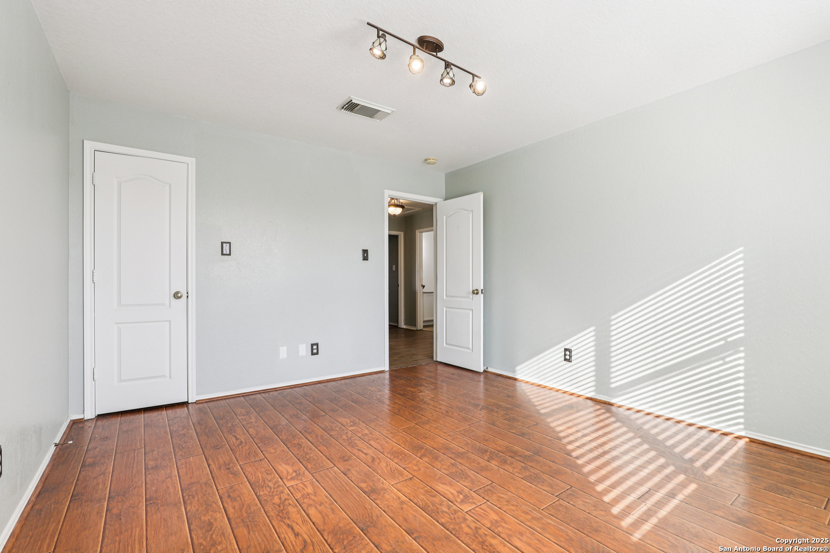 8915 Gathering Pass Converse, TX 78109 - Photo 23 of 37 a view of an empty room with wooden floor