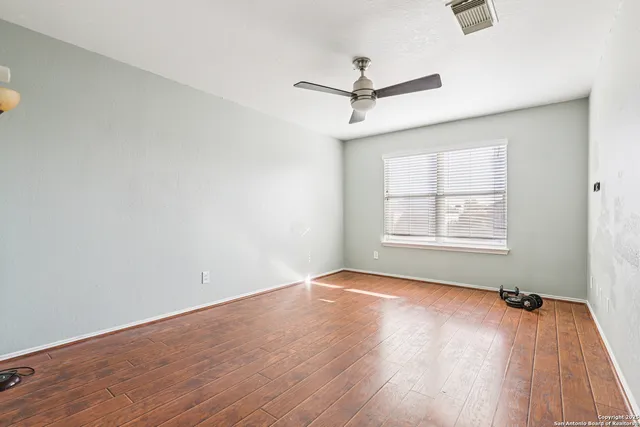 a bathroom with a granite countertop toilet and a sink