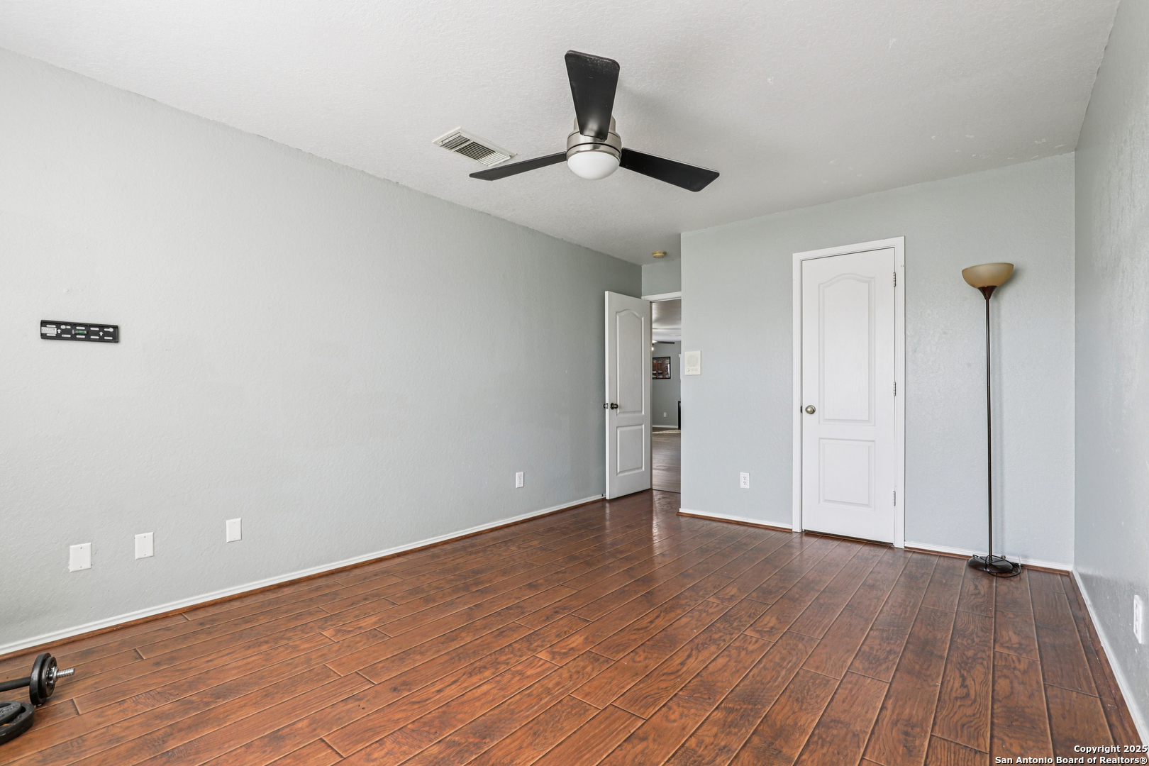 8915 Gathering Pass Converse, TX 78109 - Photo 25 of 37 a view of an empty room and wooden floor