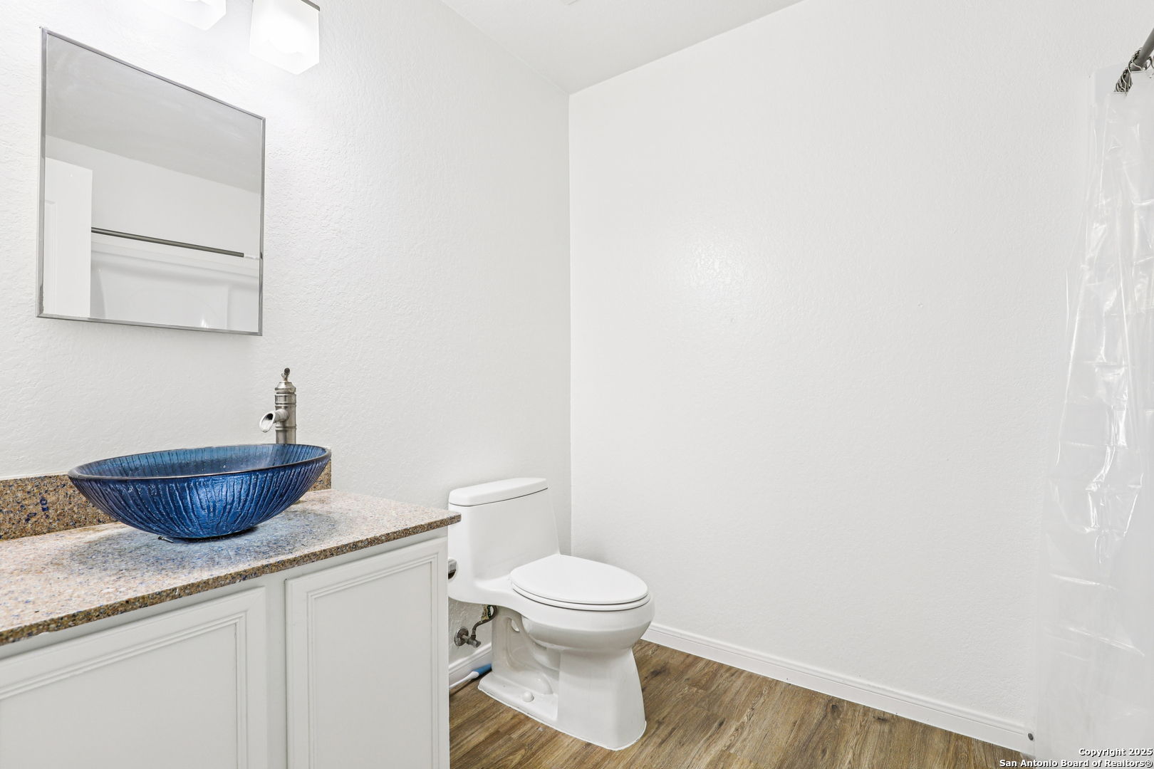 8915 Gathering Pass Converse, TX 78109 - Photo 26 of 37 a bathroom with a granite countertop toilet and a sink