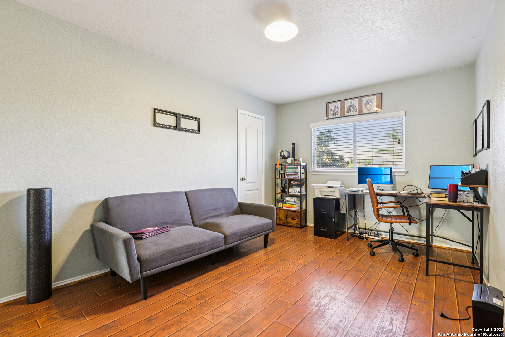 8915 Gathering Pass Converse, TX 78109 - Photo 27 of 37 a living room with furniture and a wooden floor