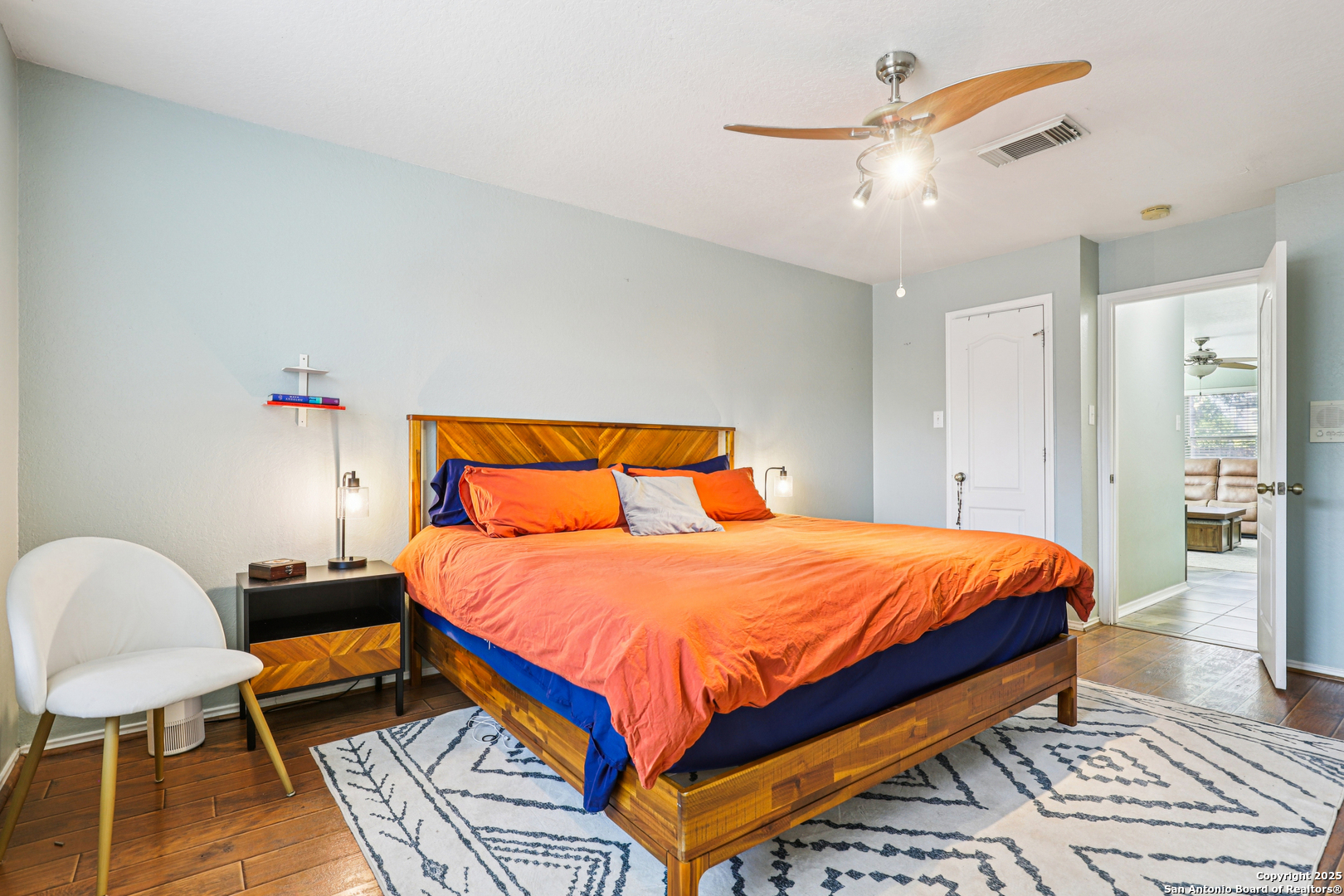 8915 Gathering Pass Converse, TX 78109 - Photo 29 of 37 a bedroom with a bed a chandelier and a dresser