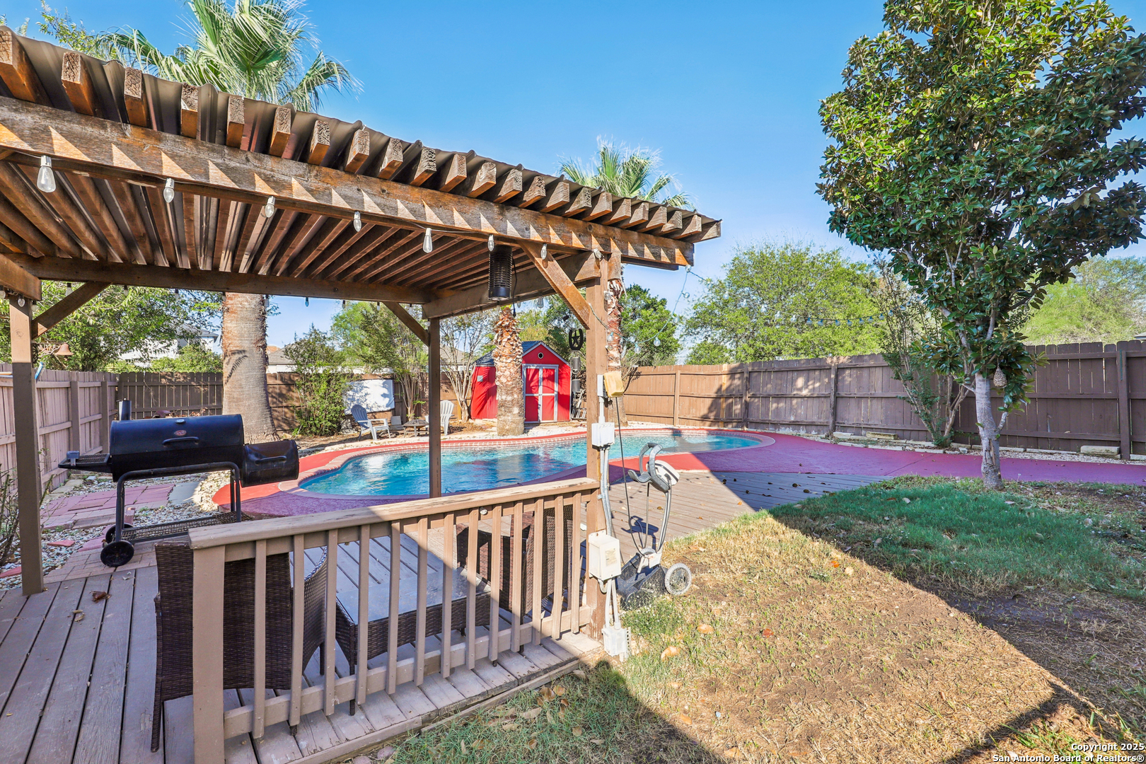 8915 Gathering Pass Converse, TX 78109 - Photo 31 of 37 a view of a patio with table and chairs under an umbrella with a small yard