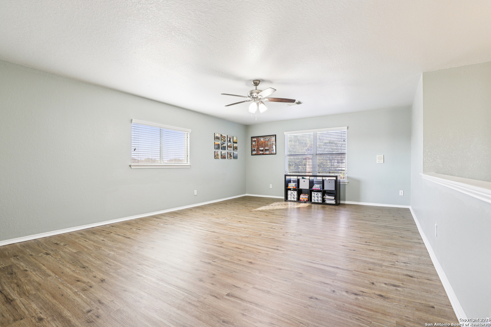 8915 Gathering Pass Converse, TX 78109 - Photo 4 of 37 an empty room with wooden floor and chandelier
