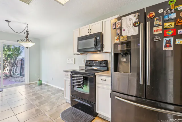 a kitchen with stainless steel appliances granite countertop a refrigerator and a stove