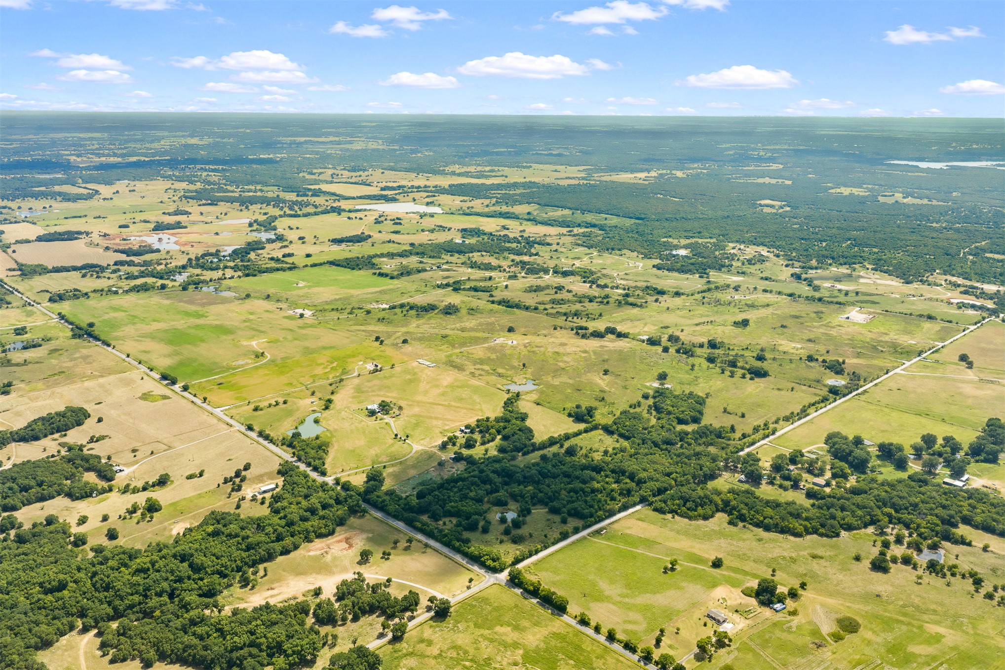 4 Keller Road Wilson, OK 73463 - Photo 3 of 32 Expansive acreage featuring a mix of open pastures and dense tree lines