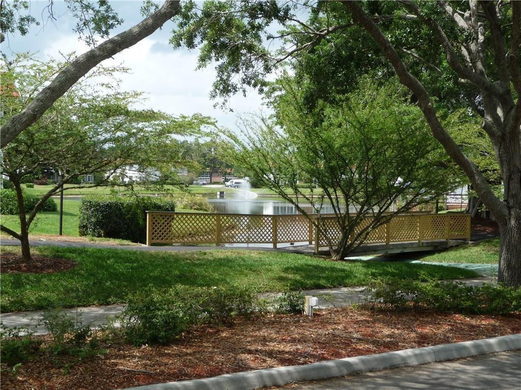 1225 Northwest 21st Street, Unit 912 Stuart, FL 34994 - Photo 33 of 34 Common Area Sidewalk & Lake View