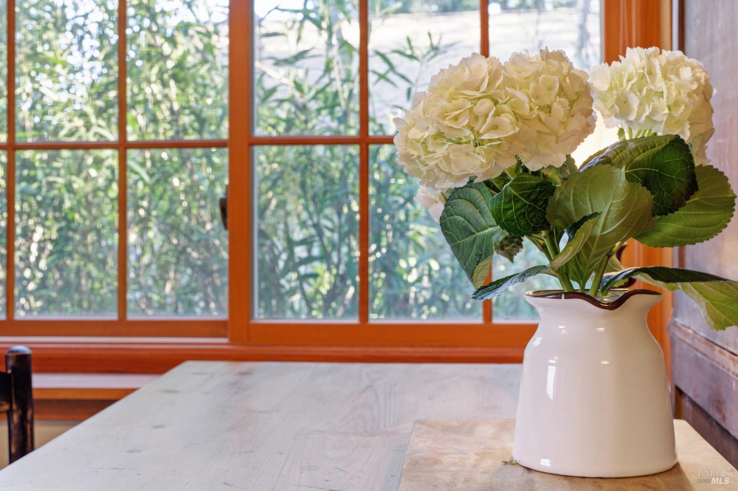 151 High Street Calistoga, CA 94515 - Photo 16 of 52 a white vase with white and yellow flowers