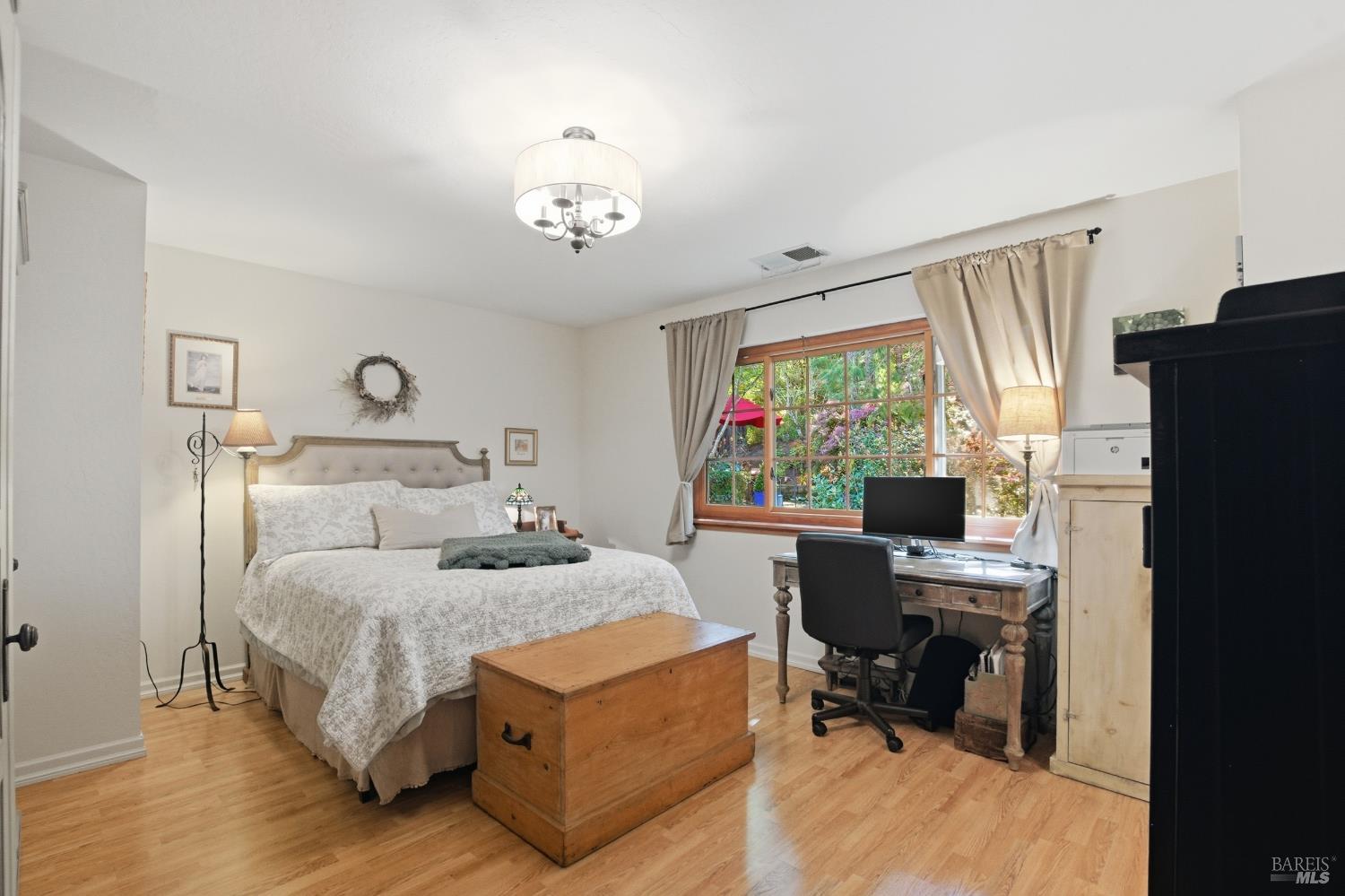 151 High Street Calistoga, CA 94515 - Photo 22 of 52 a bedroom with a bed and a desk