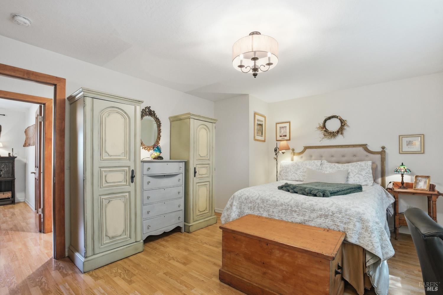 151 High Street Calistoga, CA 94515 - Photo 23 of 52 a bedroom with a bed and wooden floor