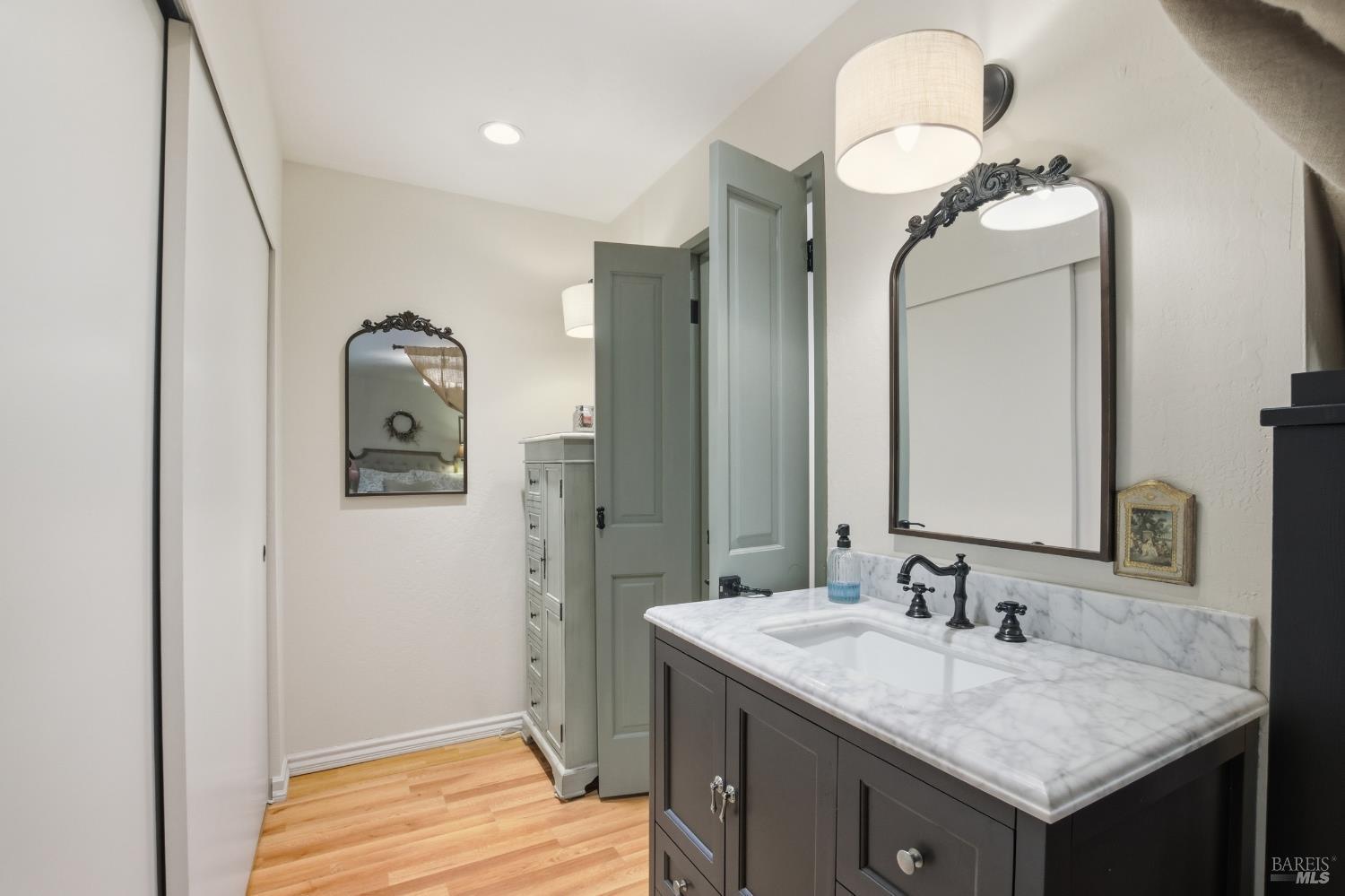 151 High Street Calistoga, CA 94515 - Photo 24 of 52 a bathroom with a granite countertop sink and a mirror