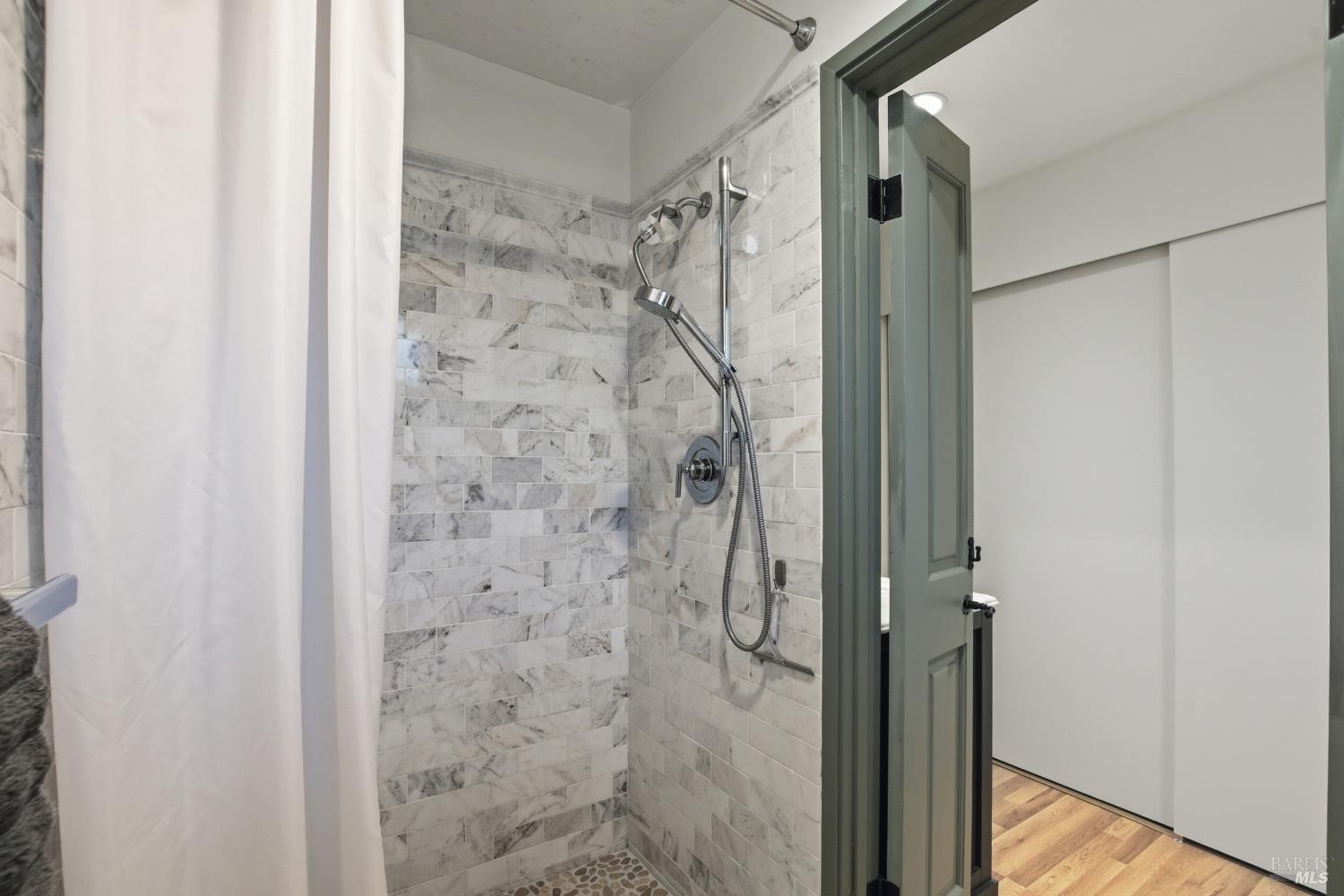 151 High Street Calistoga, CA 94515 - Photo 26 of 52 a bathroom with a shower and a glass door