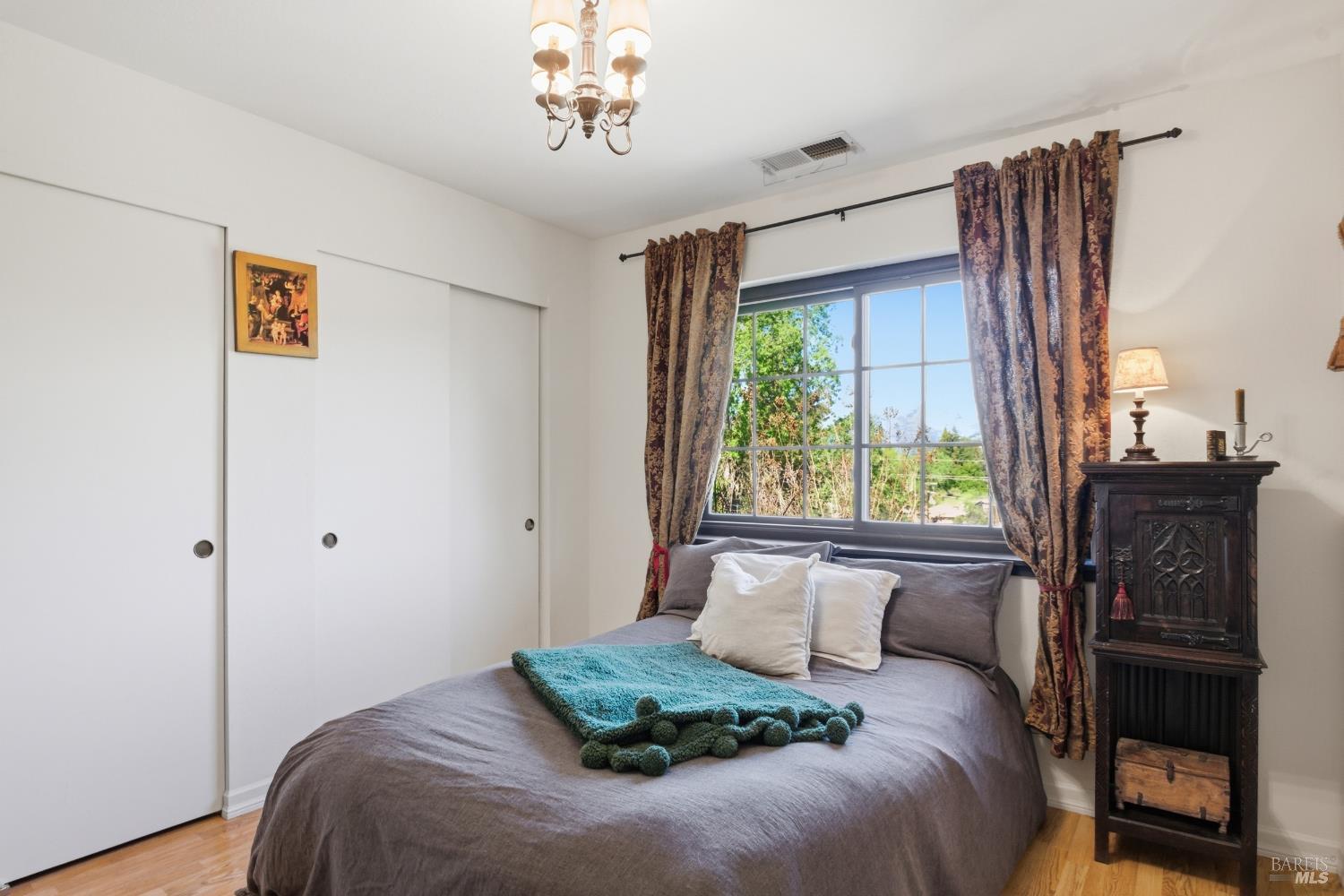 151 High Street Calistoga, CA 94515 - Photo 30 of 52 a bedroom with a bed and a table in it