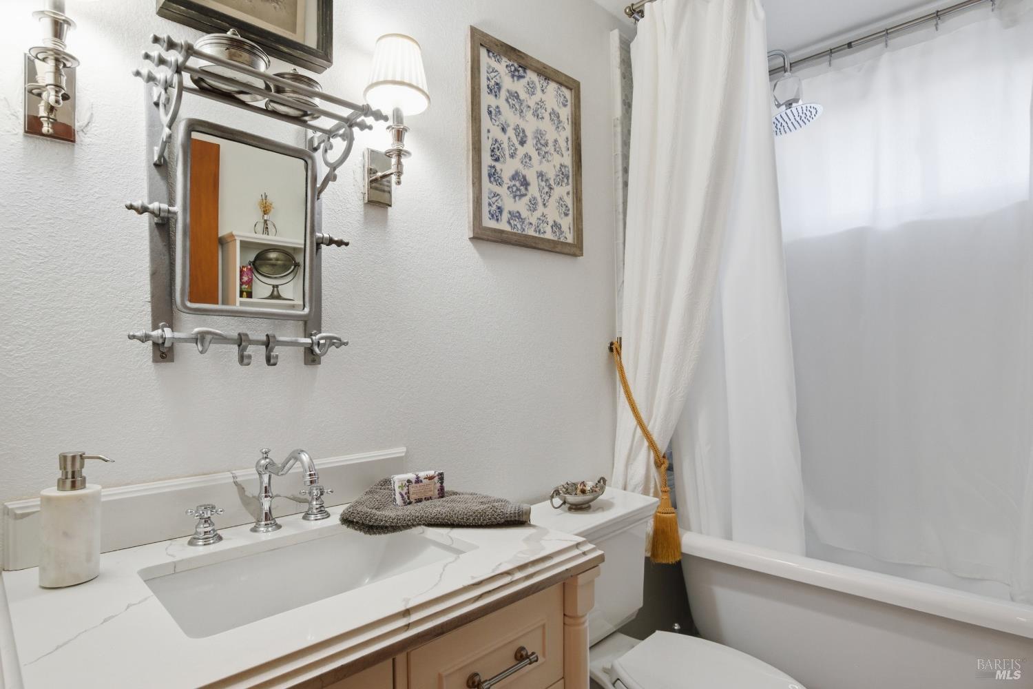 151 High Street Calistoga, CA 94515 - Photo 34 of 52 a bathroom with a sink a toilet and a mirror
