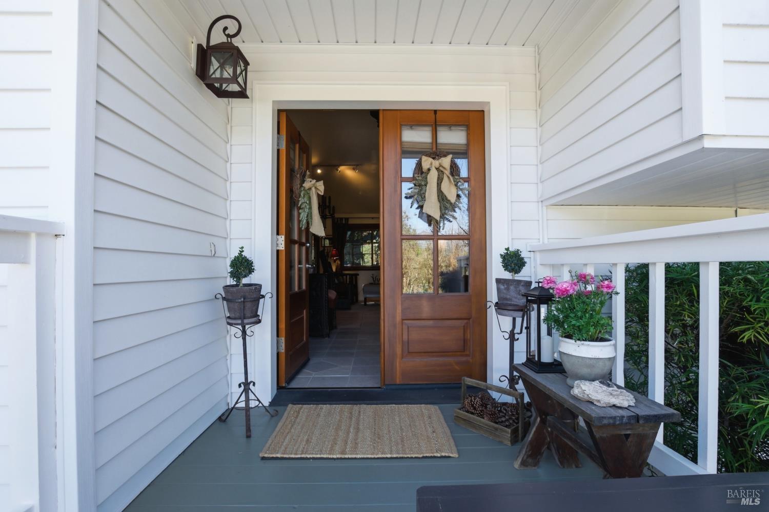 151 High Street Calistoga, CA 94515 - Photo 5 of 52 a view of a porch with chairs and potted plants