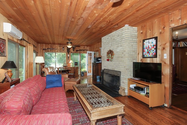 591 Plum Tree Road Barrington Hills, IL 60010 - Photo 12 of 30 a living room with furniture a flat screen tv and a fireplace