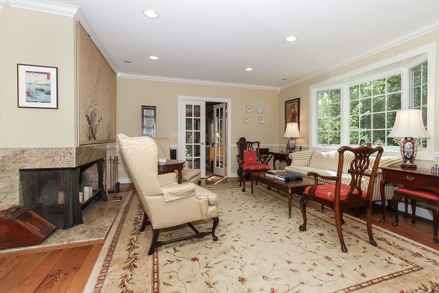 591 Plum Tree Road Barrington Hills, IL 60010 - Photo 6 of 30 a living room with furniture and a fireplace