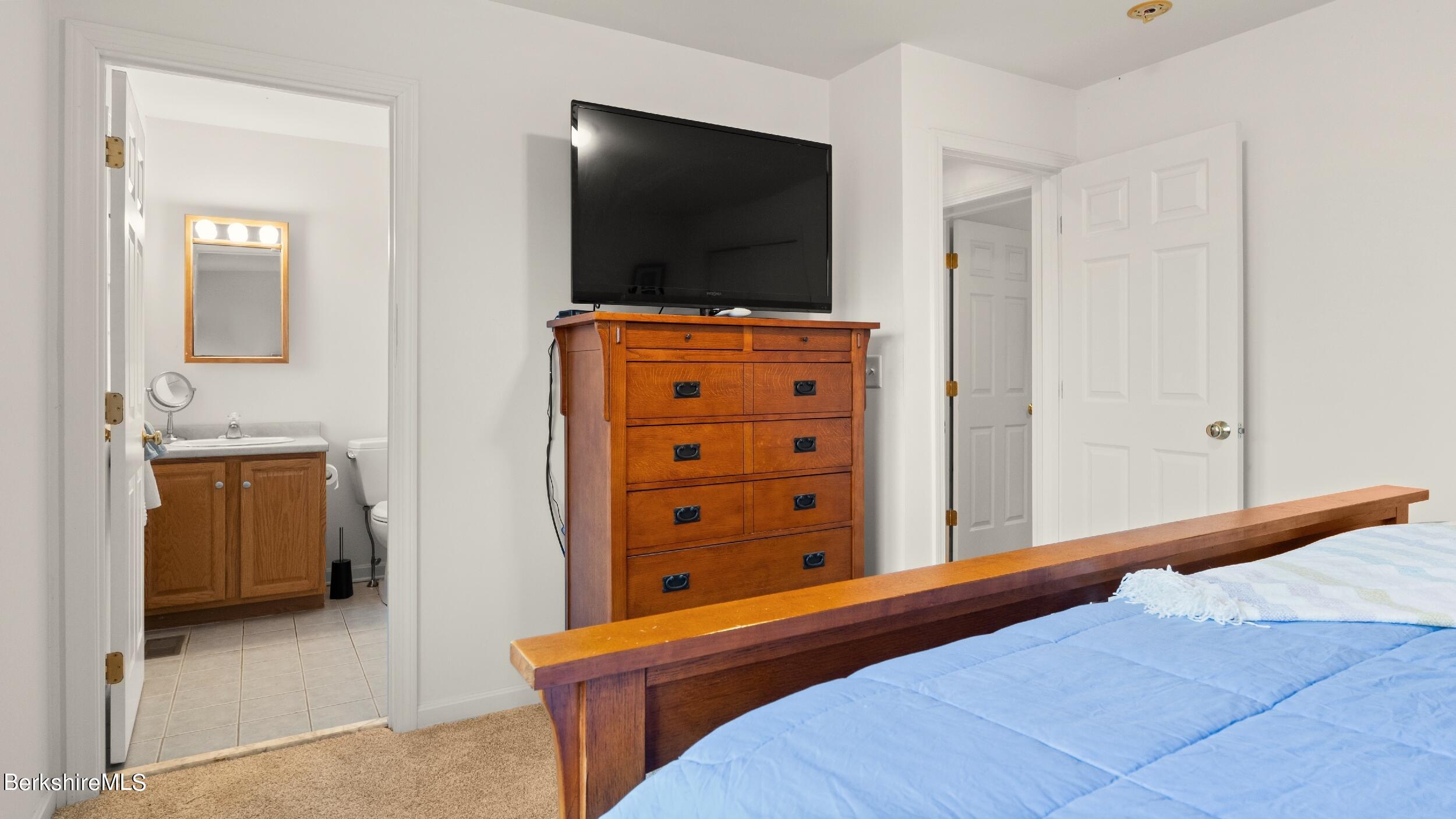 30 Norwalk Acres Road Monterey, MA 01245 - Photo 16 of 30 a bedroom with a bed and a flat screen tv