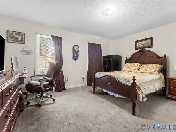 a bedroom with a bed and a television