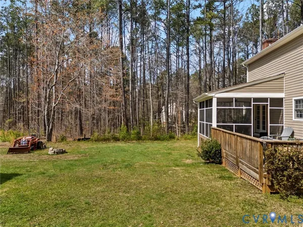 a view of a backyard with table and chairs and a barbeque