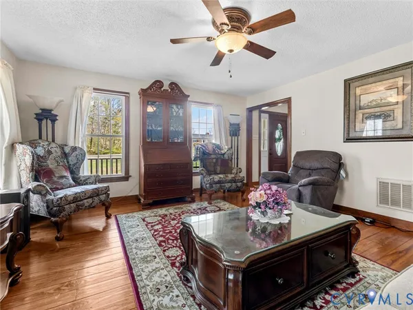 a living room with furniture and wooden floor